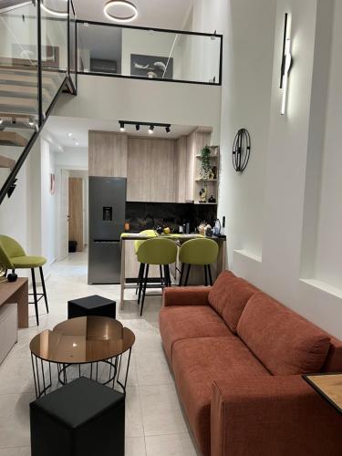 un soggiorno con divano e una cucina di The Loft Project a Alexandroupoli
