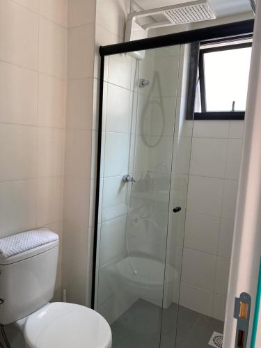 a bathroom with a shower and a toilet at Studio Batel in Curitiba