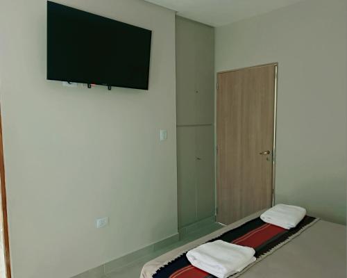 a room with a flat screen tv on a wall at Aires del Norte Apart in San Miguel de Tucumán