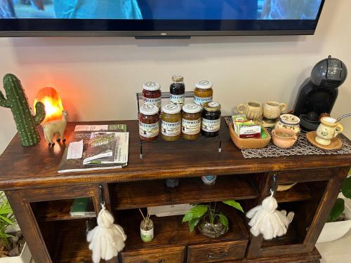 a wooden table with jars of honey on it at Aires del Norte Apart in San Miguel de Tucumán