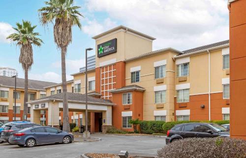 a hotel with cars parked in a parking lot at Extended Stay America Suites - Houston - Galleria - Uptown in Houston