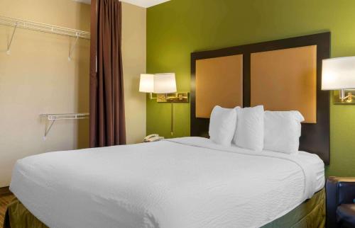 a large white bed in a hotel room at Extended Stay America Suites - Detroit - Metropolitan Airport in Romulus