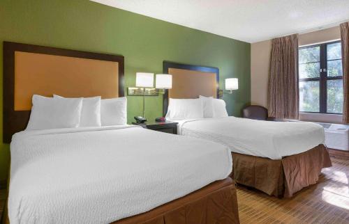 two beds in a hotel room with green walls at Extended Stay America Suites - Santa Rosa - North in Santa Rosa
