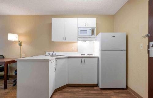 a kitchen with white cabinets and a white refrigerator at Extended Stay America Suites - Santa Rosa - North in Santa Rosa