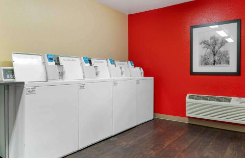 a room with white washing machines and a red wall at Extended Stay America Suites - Santa Rosa - North in Santa Rosa