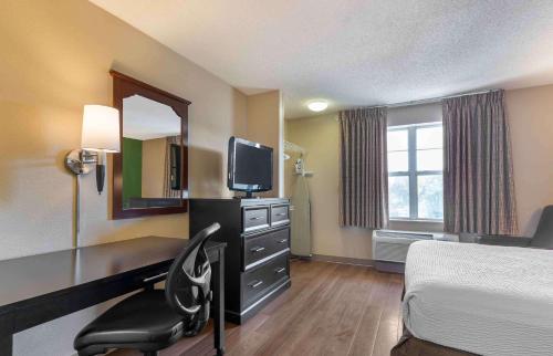 a hotel room with a bed and a desk and a television at Extended Stay America Suites - San Jose - Edenvale - North in San Jose