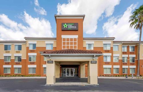 an orange building with a sign on it at Extended Stay America Select Suites - Orlando - Southpark - Equity Row in Orlando