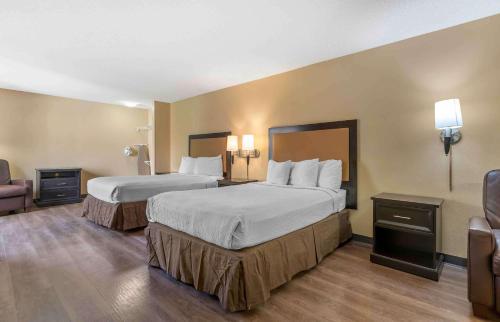 a hotel room with two beds and a chair at Extended Stay America Suites - San Jose - Edenvale - North in San Jose