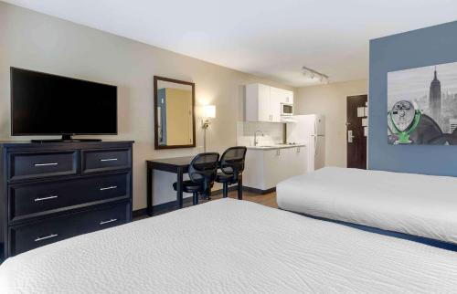 a hotel room with two beds and a desk with a television at Extended Stay America Suites - San Ramon - Bishop Ranch - East in San Ramon