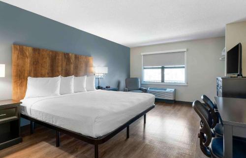 a hotel room with a bed and a chair at Extended Stay America Suites - San Ramon - Bishop Ranch - East in San Ramon