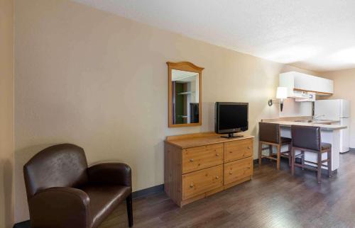 a hotel room with a desk with a tv and a chair at Extended Stay America Suites - Cleveland - Airport - North Olmsted in North Olmsted