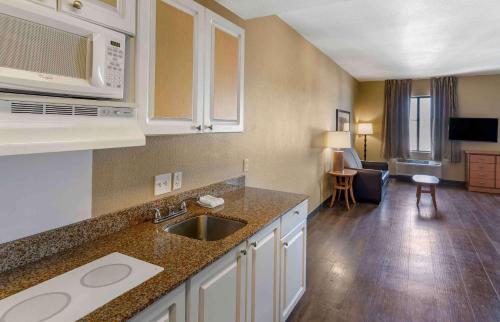 a kitchen with a sink and a living room at Extended Stay America Suites - San Rafael - Francisco Blvd East in San Rafael