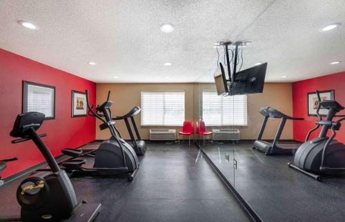 a gym with several exercise bikes in a room with red walls at Extended Stay America Suites - Cleveland - Airport - North Olmsted in North Olmsted