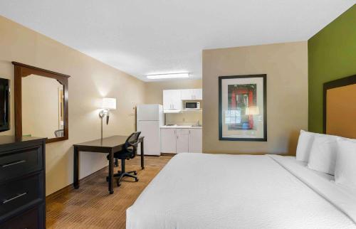 a hotel room with a bed and a desk with a computer at Extended Stay America Suites - Virginia Beach - Independence Blvd in Virginia Beach