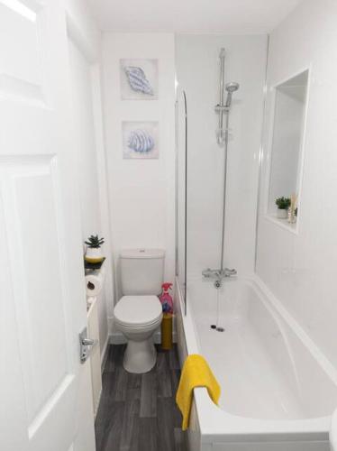 a white bathroom with a toilet and a shower at 2 Bed Terrace 5 Minutes from Anfield Stadium in Liverpool