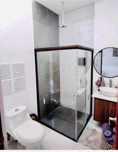 a bathroom with a shower and a toilet and a sink at Natural Arenas 47 ! in Herradura