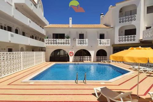 a swimming pool in the middle of a building at 403 - Oura - 2 bedroom- Sea View in Albufeira