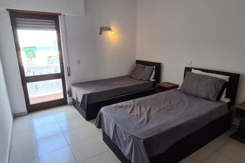 a hotel room with two beds and a window at 403 - Oura - 2 bedroom- Sea View in Albufeira