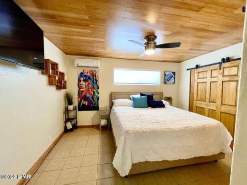 a bedroom with a bed and a ceiling fan at Million-dollar Lake view on the Parker Strip! in Parker