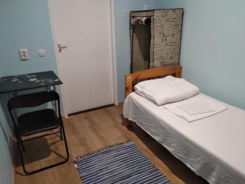 a small bedroom with a bed and a mirror at Weekly Hostel - for Solo long term travelers in Tallinn