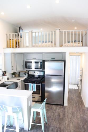 a kitchen with stainless steel appliances and white cabinets at Parker Dreamin with Casita in Cross Roads