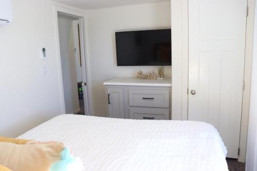 a bedroom with a bed and a flat screen tv at Parker Dreamin with Casita in Cross Roads