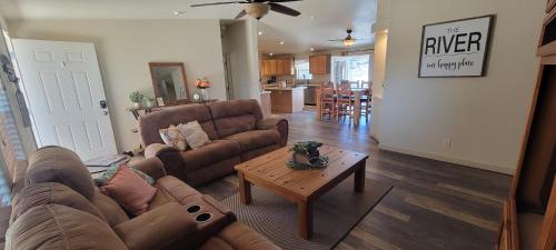 a living room with a couch and a coffee table at Parker Strip pool house with game room! in Parker