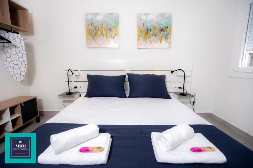 a bedroom with a bed with two pillows at Mara 2 Playa del Burrero junto al mar, wifi gratis in Ingenio