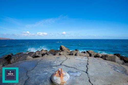 a rock on the beach with the ocean in the background at Mara 2 Playa del Burrero junto al mar, wifi gratis in Ingenio