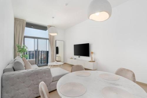 a living room with a couch and a table at 1bdr in Belgravia Heights - JVC - Dubai in Dubai