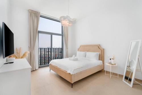 a bedroom with a bed and a large window at 1bdr in Belgravia Heights - JVC - Dubai in Dubai