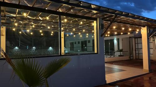 a pergola with lights on a patio at night at CASA BRAVO in Huamantla
