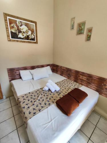 two beds in a room with towels on them at Aparecida Akuto's Pousada in Aparecida