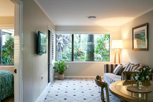 a living room with a couch and a table at Emerald Inn on Takapuna Beach in Auckland