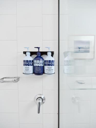 a bathroom door with two bottles of cleaning products on it at Saint Kilda Beach Hotel - formerly Rydges St Kilda in Melbourne