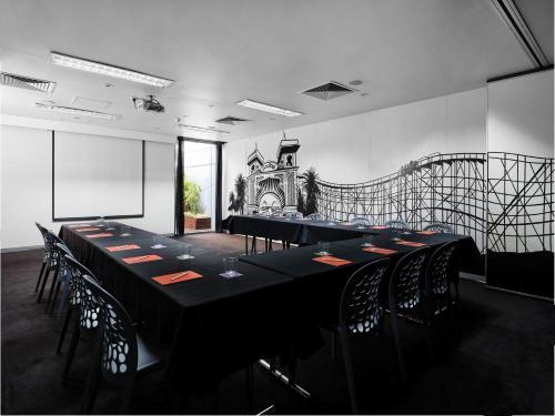 a conference room with a long table and chairs at Saint Kilda Beach Hotel - formerly Rydges St Kilda in Melbourne