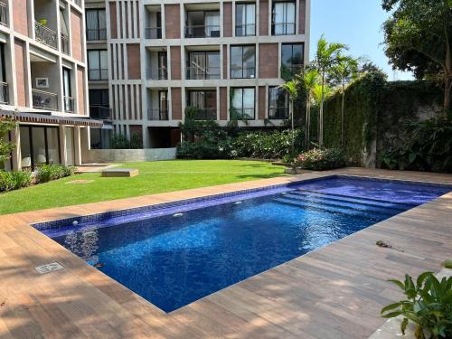 a swimming pool in front of a building at Gomez de castro apartments in Asuncion