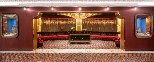 a living room with red chairs and a fireplace at Hotel Indigo Guangzhou Haixinsha by IHG - Free Shuttle Bus to Canton Fair Complex during Canton Fair period in Guangzhou