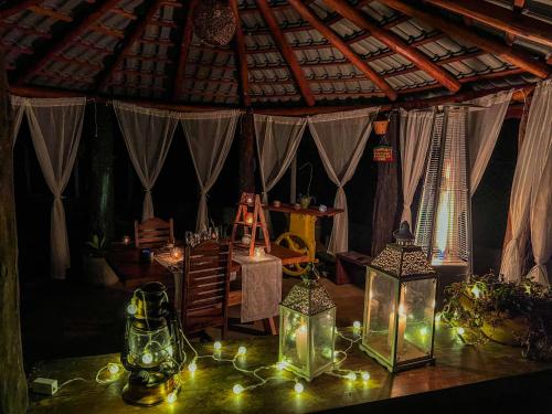 a room with many candles and lanterns on a table at Camacica pousada in Miracatu