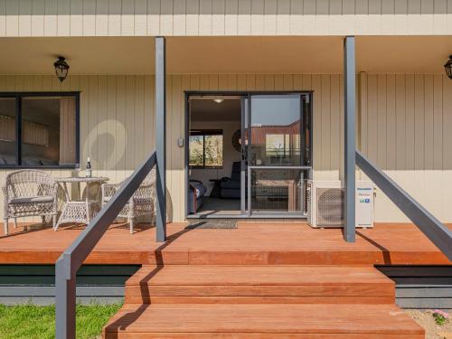 a front porch of a home with a wooden deck at Gold'n Thames - Thames Holiday Home in Thames