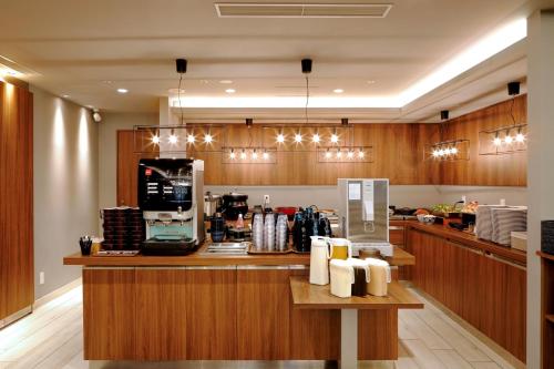 a kitchen with a counter with a coffee shop at Travelodge Sapporo Susukino in Sapporo