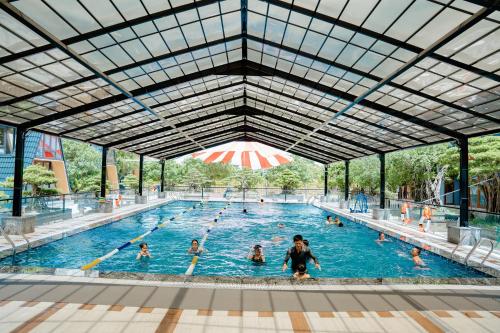 a group of people in a swimming pool at Sunny Garden Riverside Hotel Ninh Binh in Ninh Binh