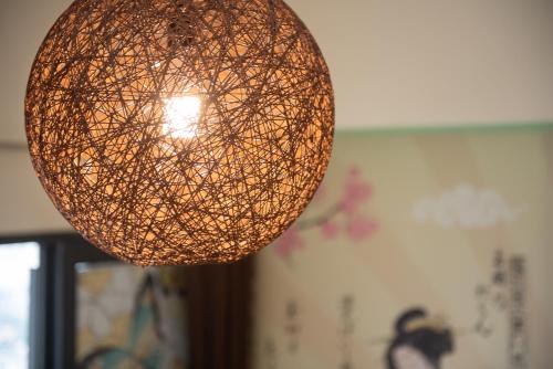 a hanging orb light fixture in a room at Kisetsu no ie, KLCC Kuala Lumpur in Kuala Lumpur