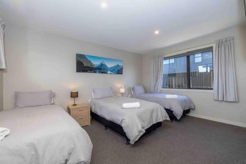 蒂阿瑙的住宿－New 2 Bedroom Apartment，一间卧室设有两张床和窗户。