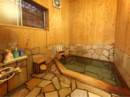 東伊豆的住宿－伊豆溫泉片瀨旅館，木制客房内的带浴缸的浴室