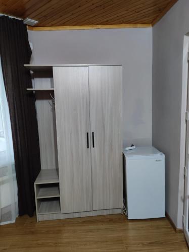 a closet with a white cabinet in a room at Осенний Иссык Куль in Cholpon-Ata