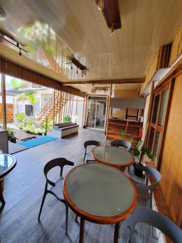 a group of tables and chairs in a room at Sun & Surf in Thulusdhoo