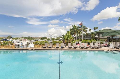 a swimming pool with lounge chairs in a resort at Bay-Ja Vu in Sarasota
