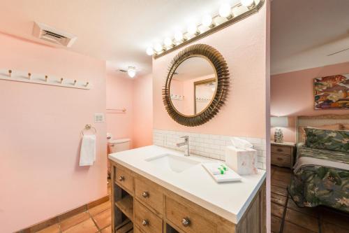 a bathroom with a sink and a mirror at Mayan Princess 101 Beachfront Resort in Port Aransas