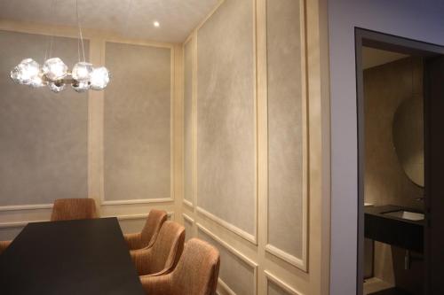a dining room with a table and chairs and a chandelier at KSL ESPLANADE HOTEL with HOT SPRING in Klang
